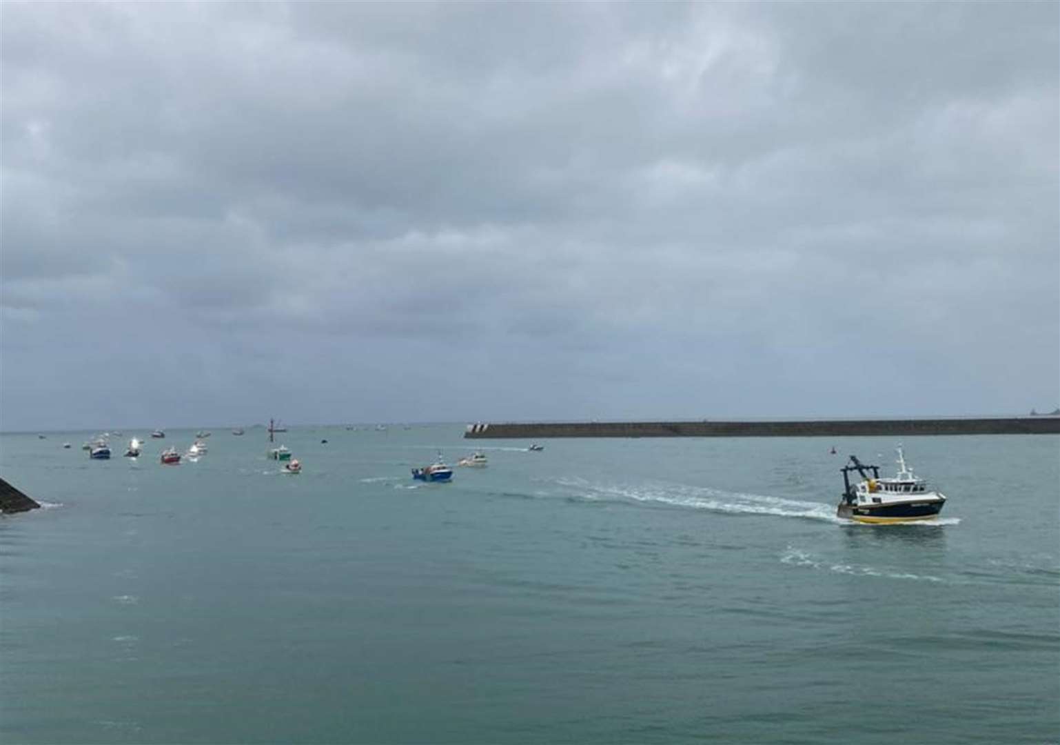 The armada of French boats enter the harbour at St Helier (Josh Dearing/PA)