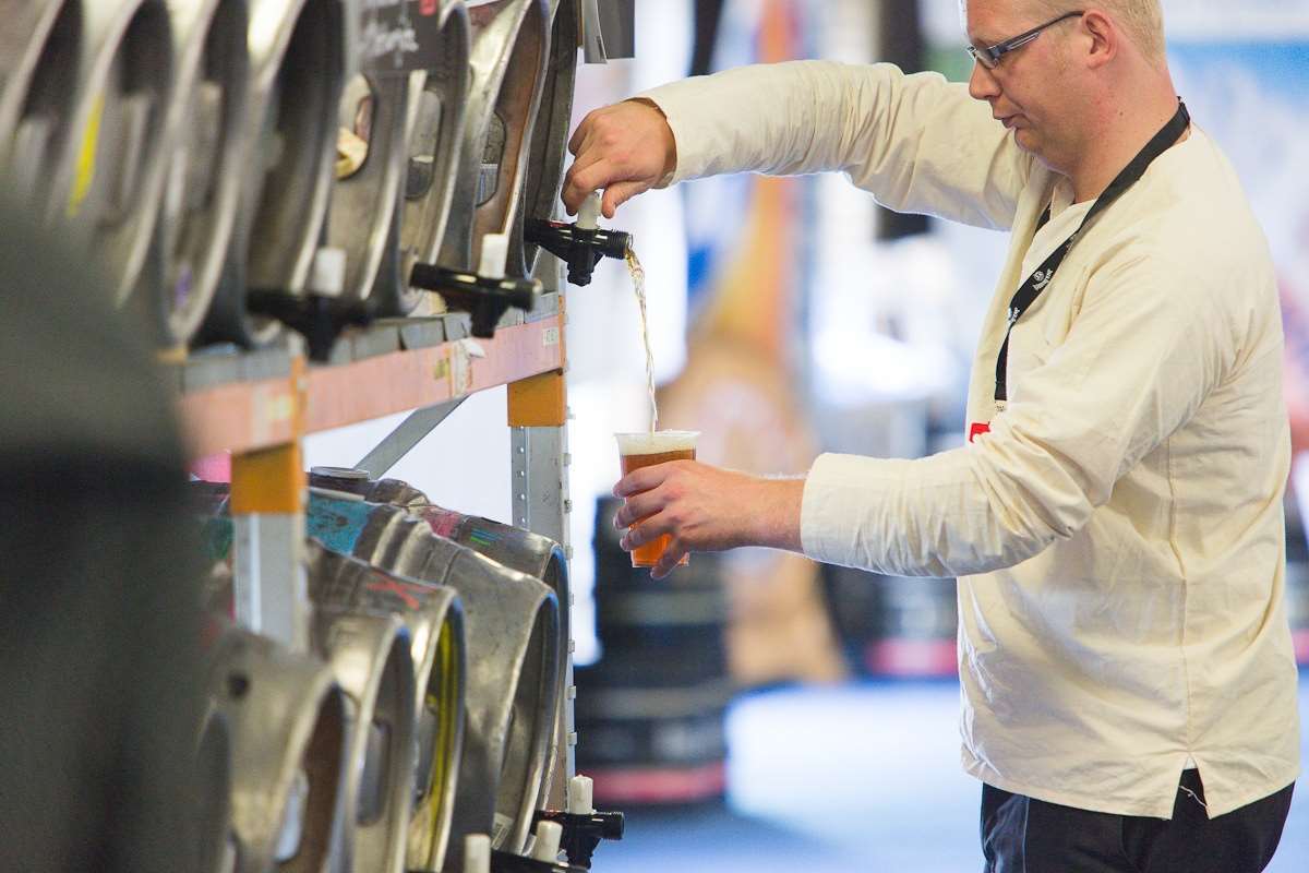 A beer lover pours an ale at the Kent County Show in Detling