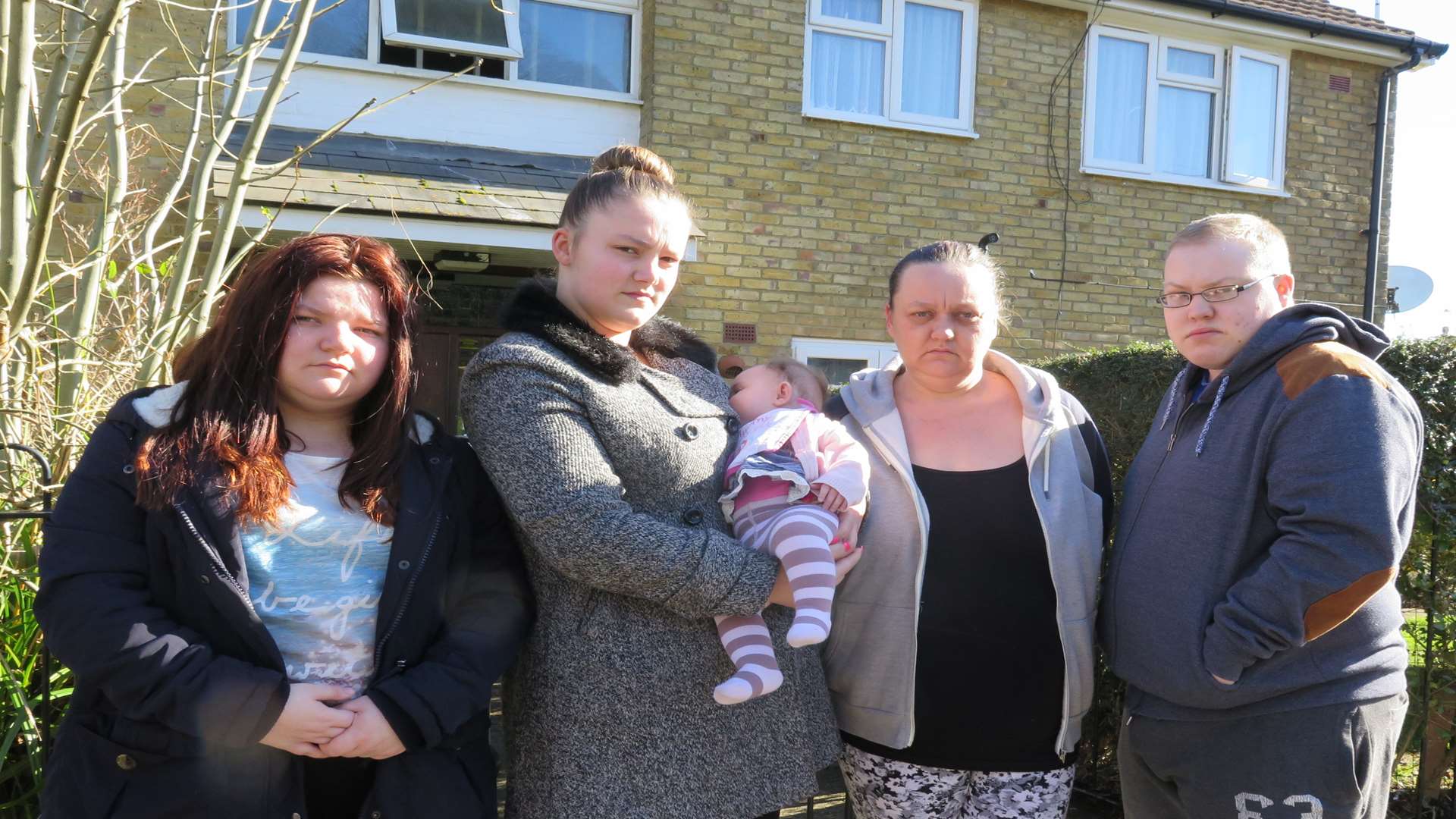 Courtney Aitcheson, 16, Shannan Copper, 20, with baby Karaleigh, Laura Aitcheson, 42, and Liam Jackson who had to flee their smoke-filled flat