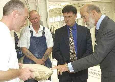 WORKMANSHIP: The Prince is shown the offcut from a large rotary saw by Ray Smith and Eamonn Lee as Canterbury Cathedral surveyor to the fabric John Burton looks on. Picture: DEREK STINGEMORE