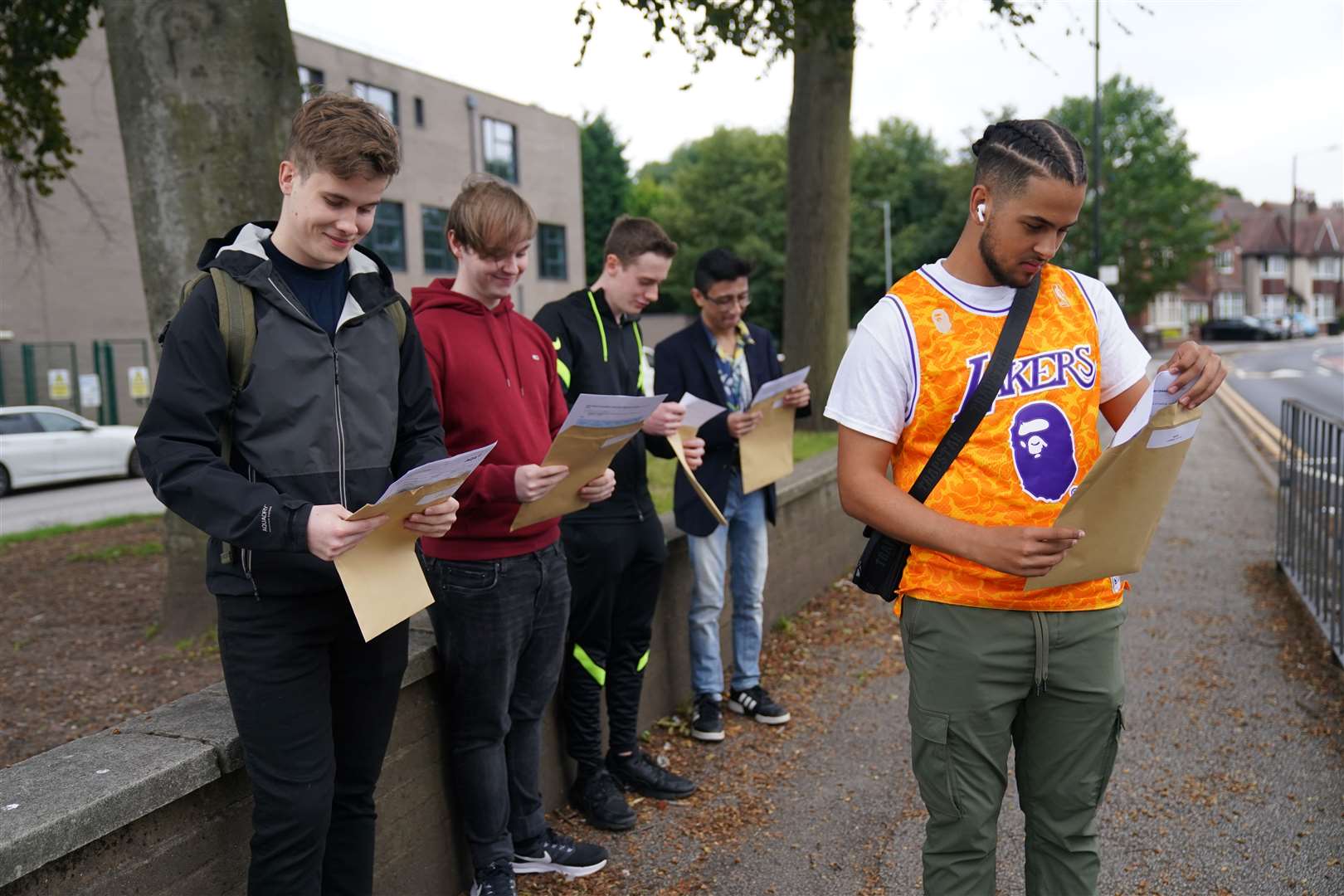 Some students at Plantsbrook School in Sutton Coldfield, went outside to open their envelopes (Jacob King/PA)