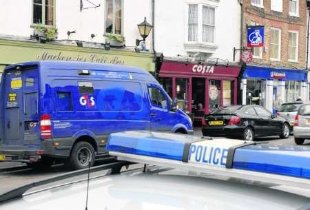 The scene of the robbery - the van can be seen on the left near the Nationwide building society.