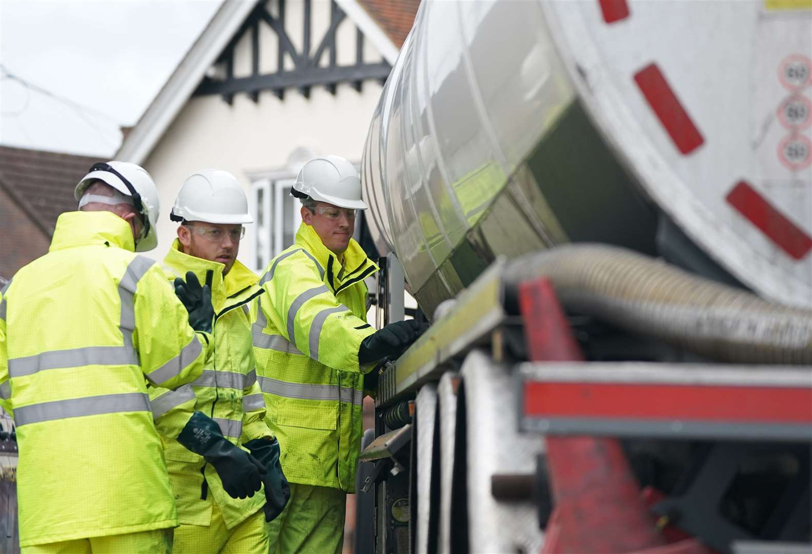 Members of the armed forces work on a fuel tanker at a garage in Waltham Abbey, Essex (PA)