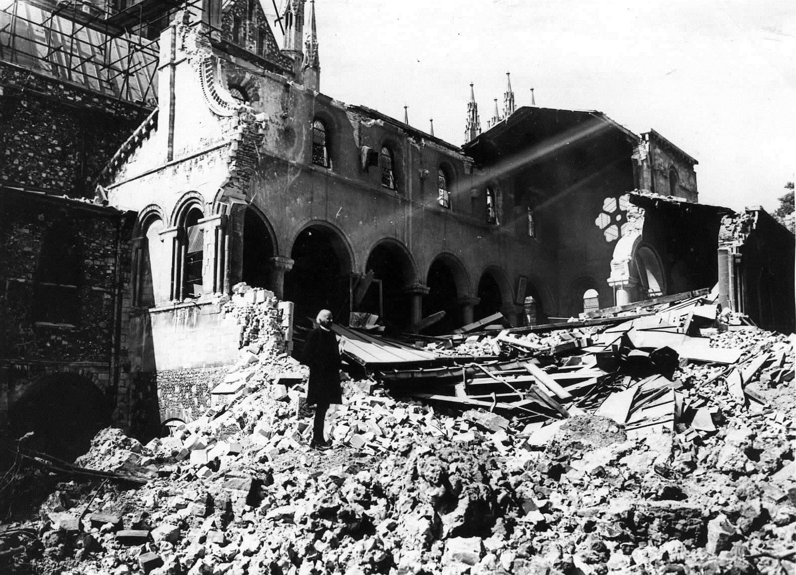 The Dean of Canterbury, Dr Hewlett Johnson, surveys the damage caused to the Cathedral - which was ultimately saved from destruction