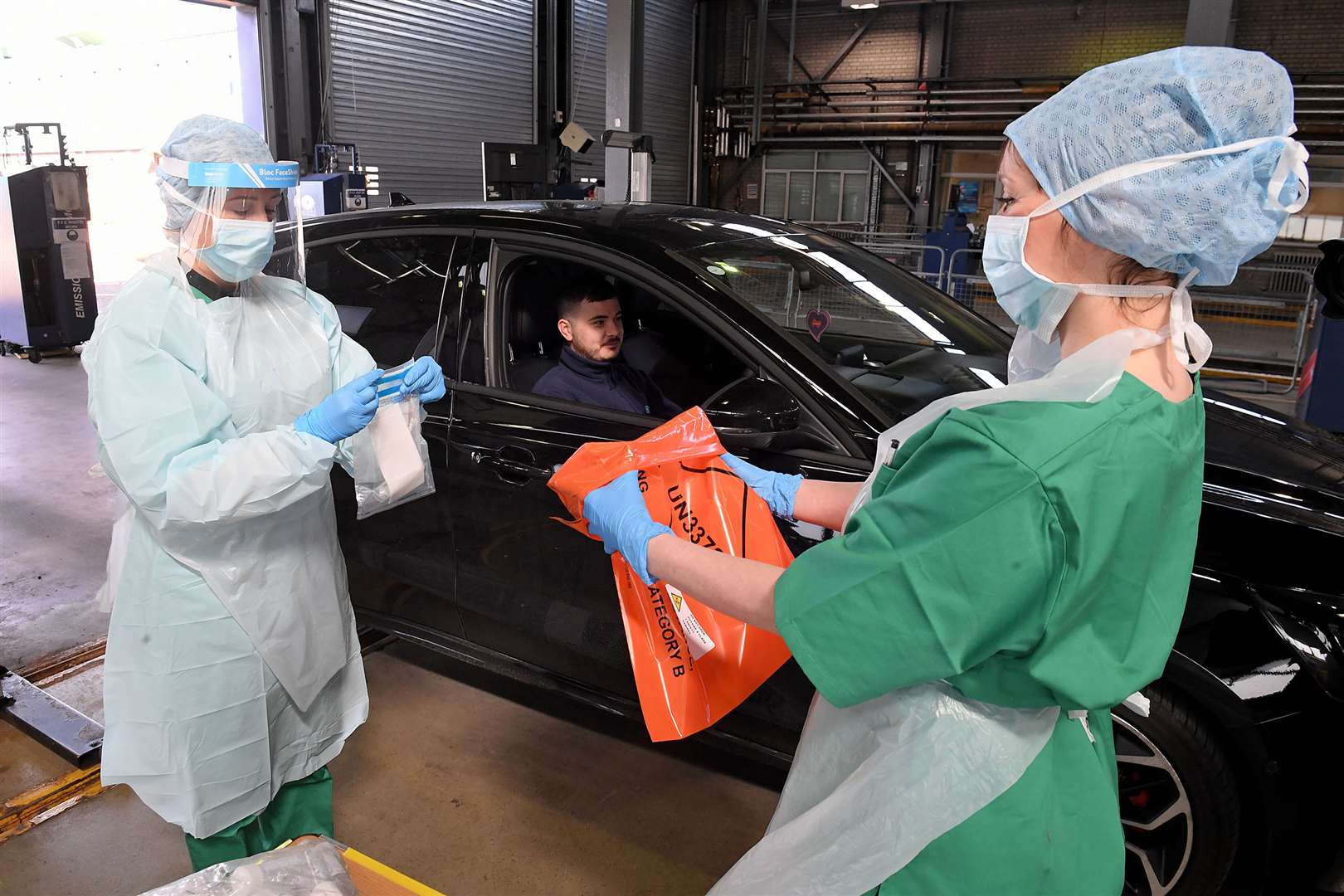 Medical staff demonstrate how they take samples at an MOT testing centre in Belfast (Justin Kernoghan/PA)