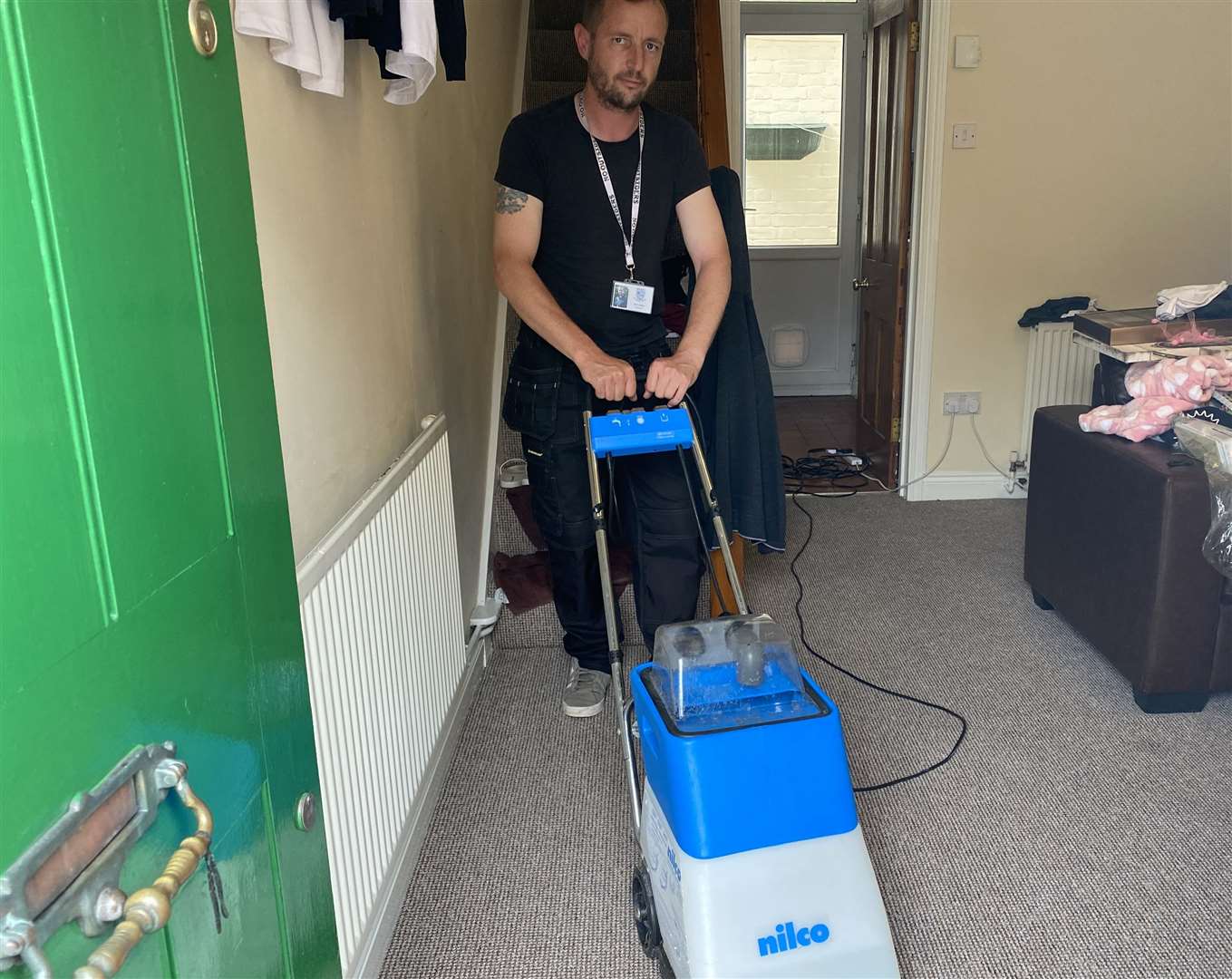 Darren Fakley is having to suck the water out of his carpet following the flooding