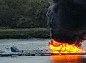 A boat fire in the River Medway, Strood, the opposite side of the astronaut. Picture: Rob Martin