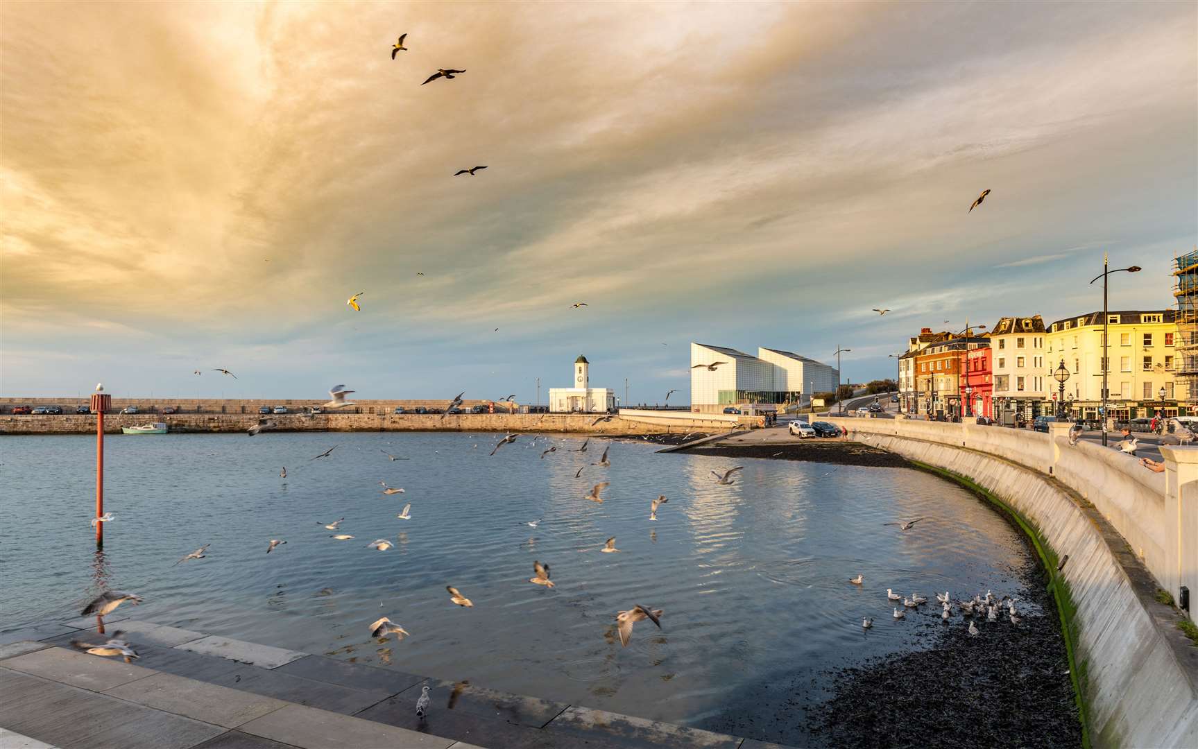 Shops and restaurants and the Turner Art Gallery building line the seafront in Margate