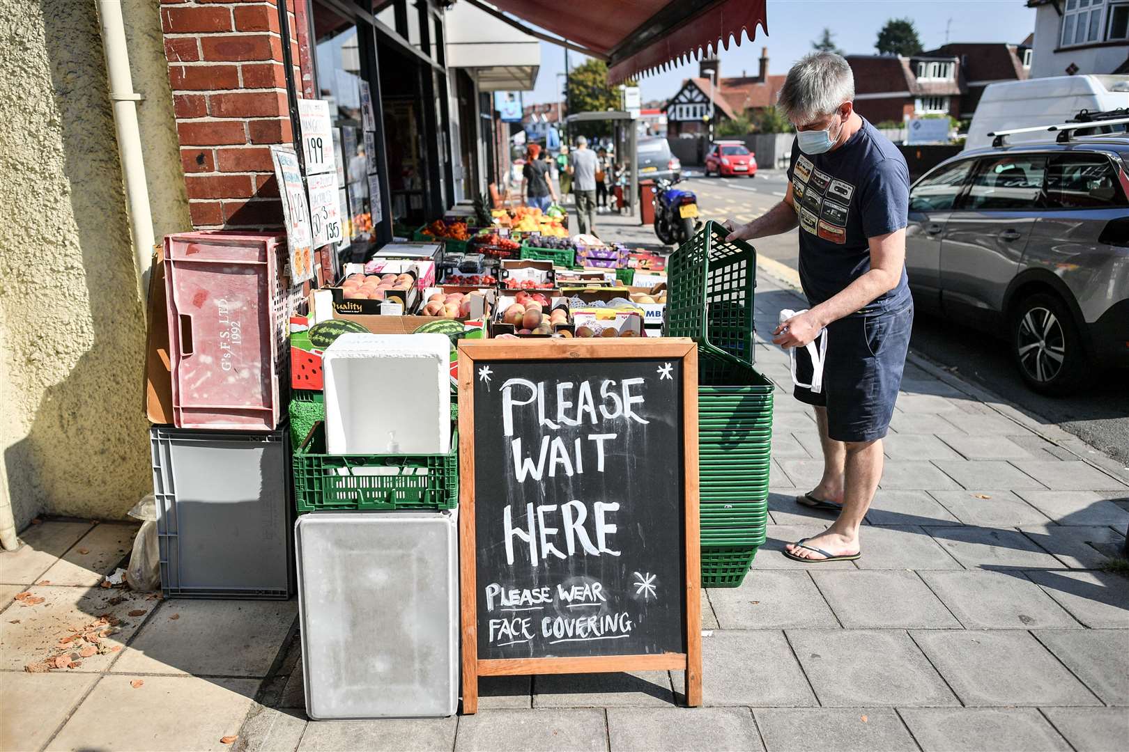 Signage outside a greengrocers on the High Street in Henleaze, Bristol, advises shoppers to wear face coverings (Ben Birchall/PA)