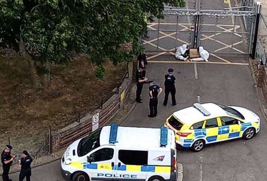 The protesters are sat outside the entrance to the animal testing laboratory