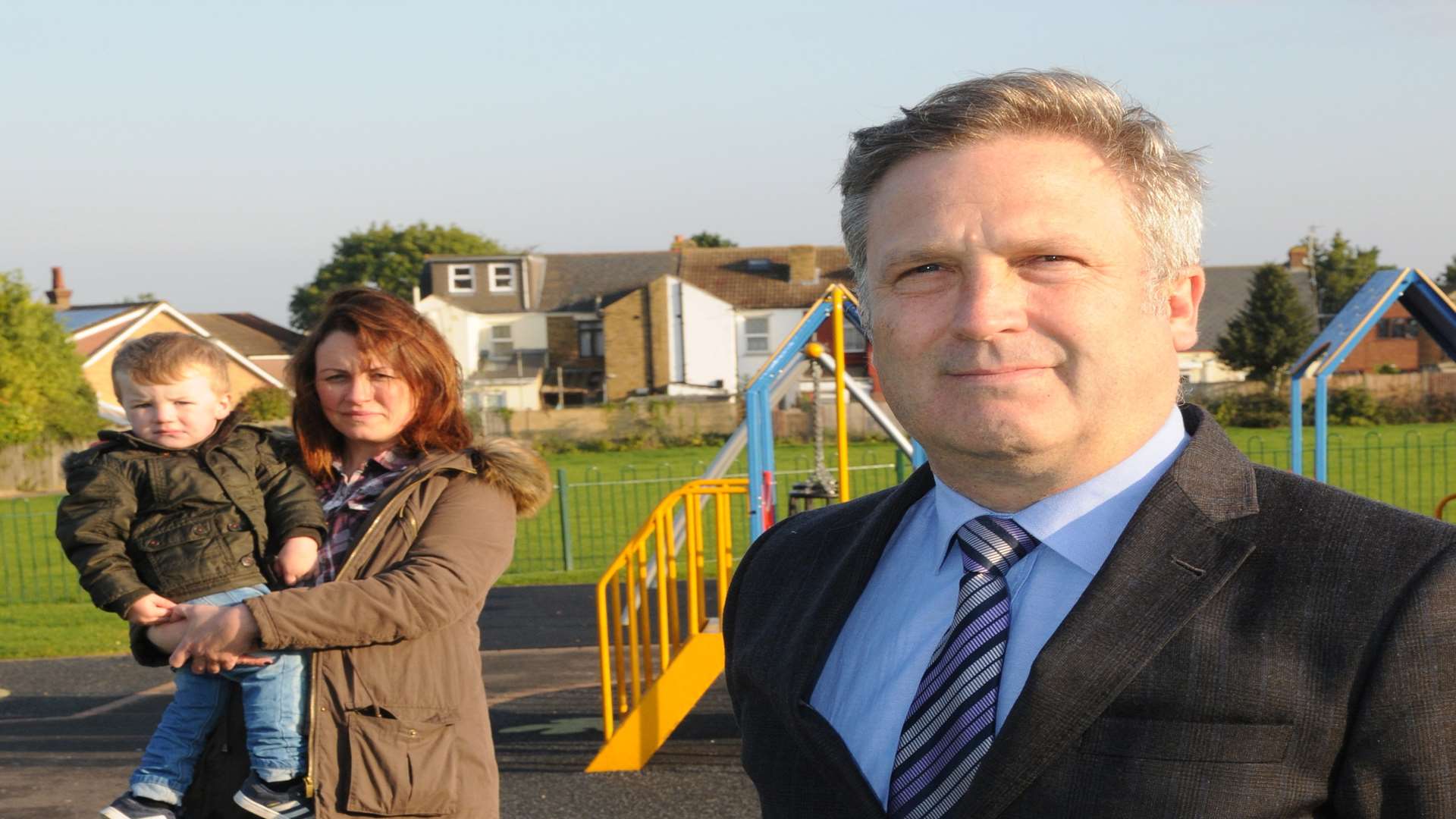 Cllr Rupert Turpin at the playground with Rachel Elphick and Harrison Milliner, two