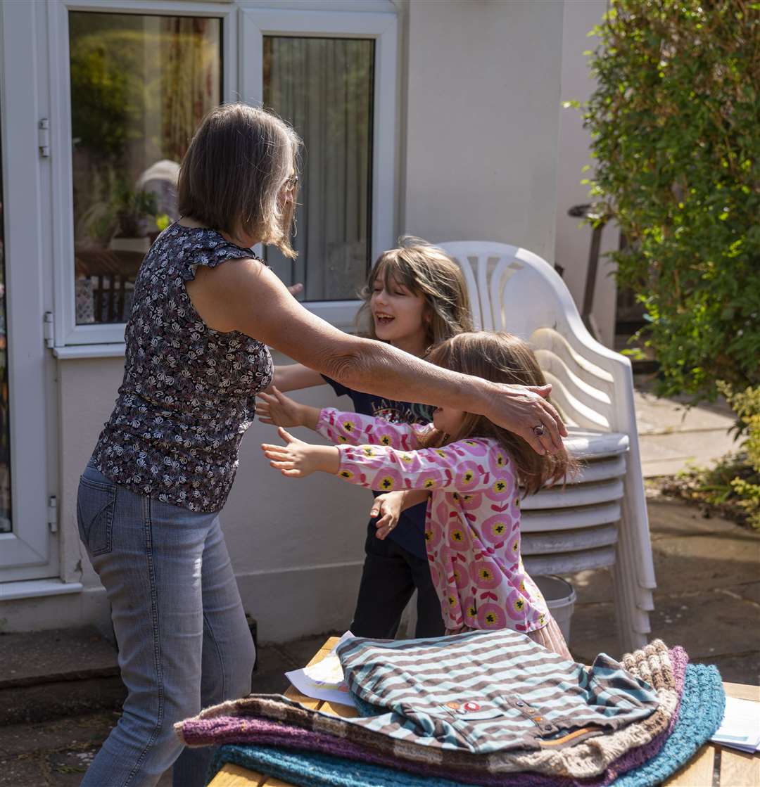 A woman is reunited with her grandchildren in Ashtead, Surrey (Giles Anderson/PA)