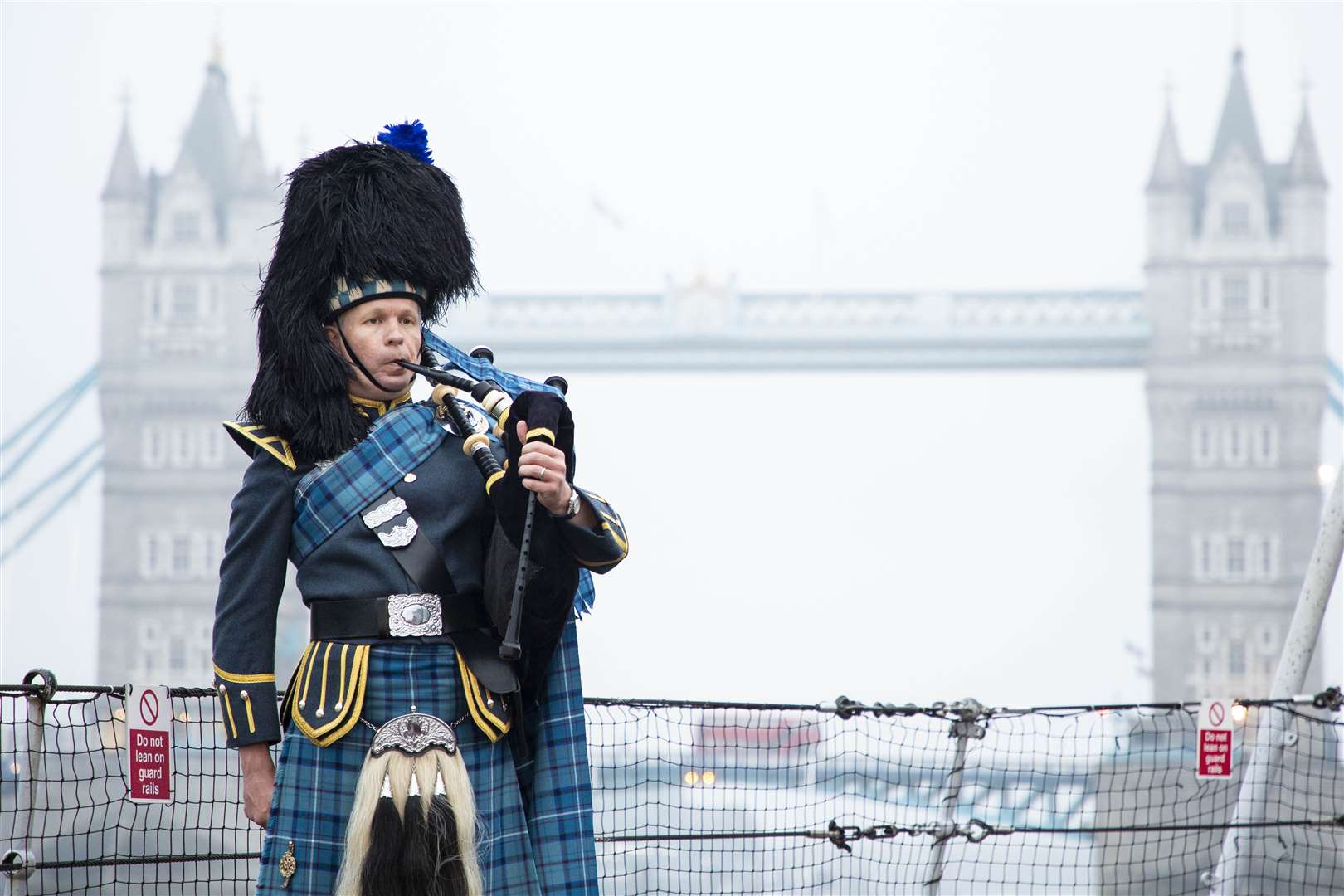 Pipe Sergeant Neil Esslemont of RAF Halton Pipes & Drums in front of Tower Bridge in London (Dave Jenkins/MoD/PA)