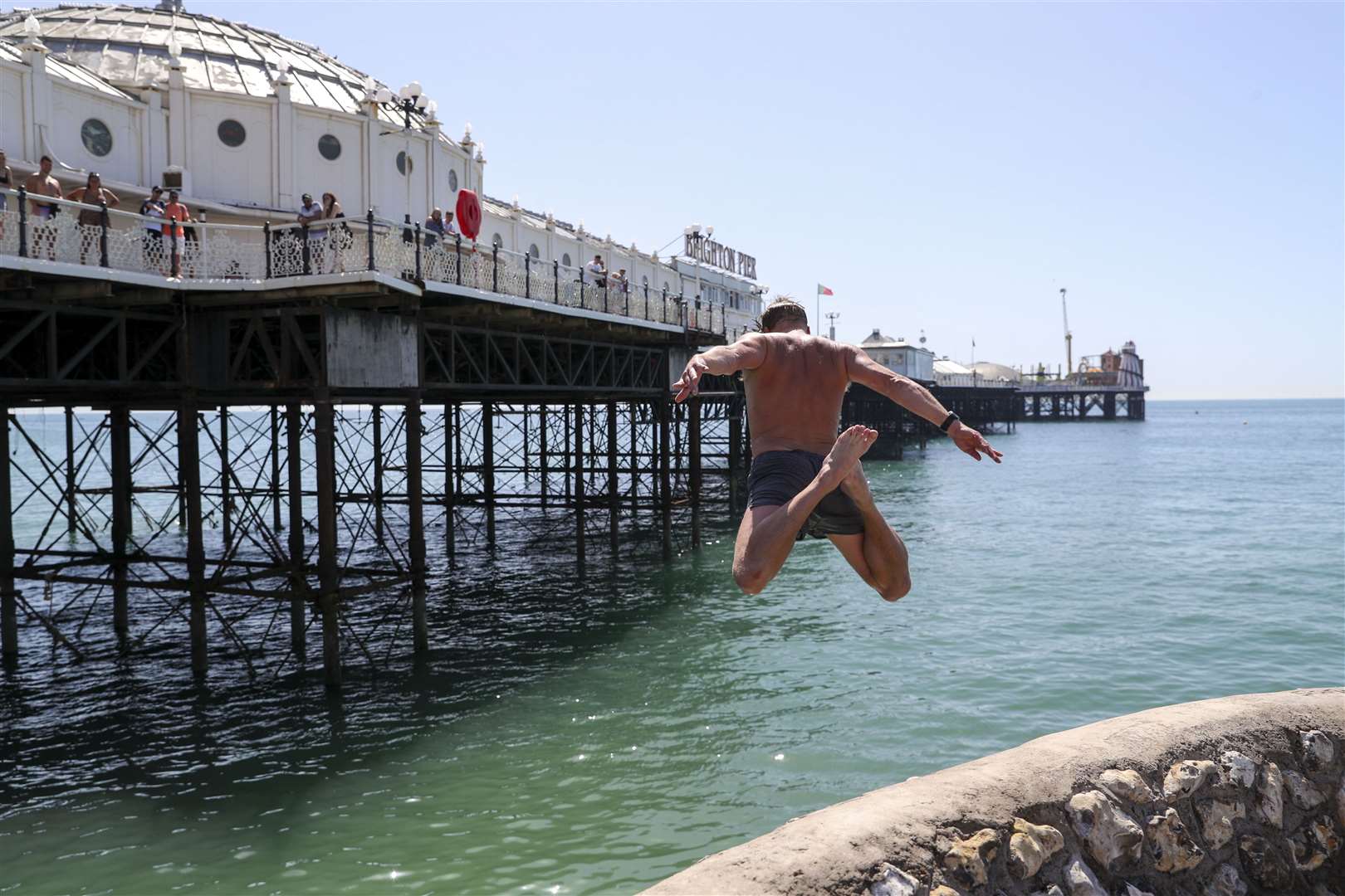 A man takes the plunge at Brighton beach (Steve Parsons)