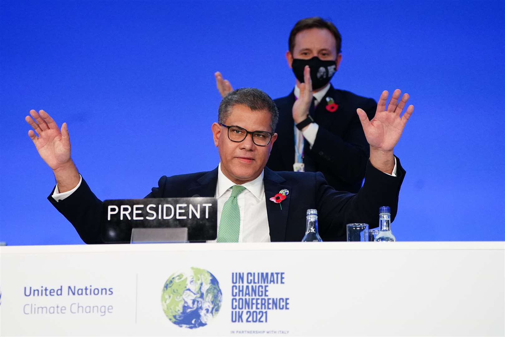 Alok Sharma President of the Cop26 climate summit, raises his hands after his speech of the closing plenary (Jane Barlow/PA)