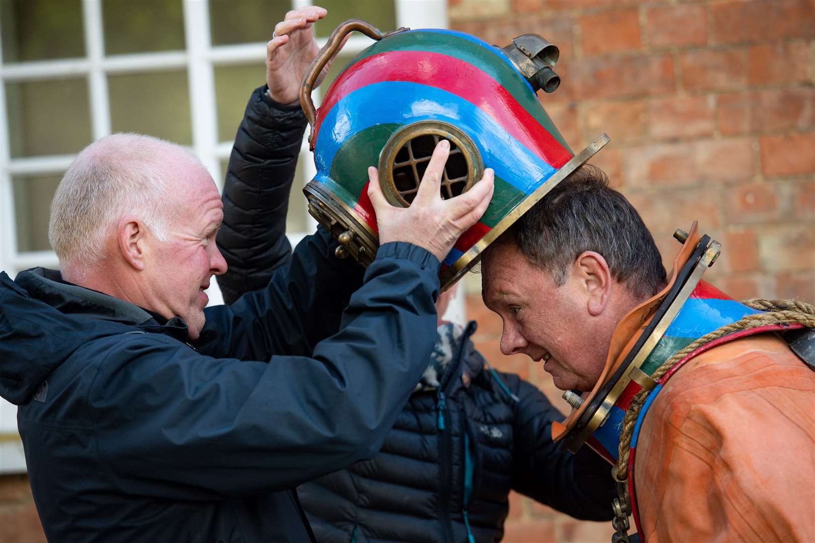 Lloyd Scott puts on his diving helmet (Jacob King/PA)