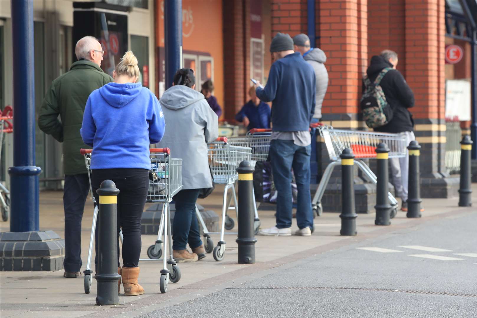 People queue at a Sainsbury’s supermarket at Colton, on the outskirts of Leeds, the day after Prime Minister Boris Johnson put the UK in lockdown to help curb the spread of the coronavirus.