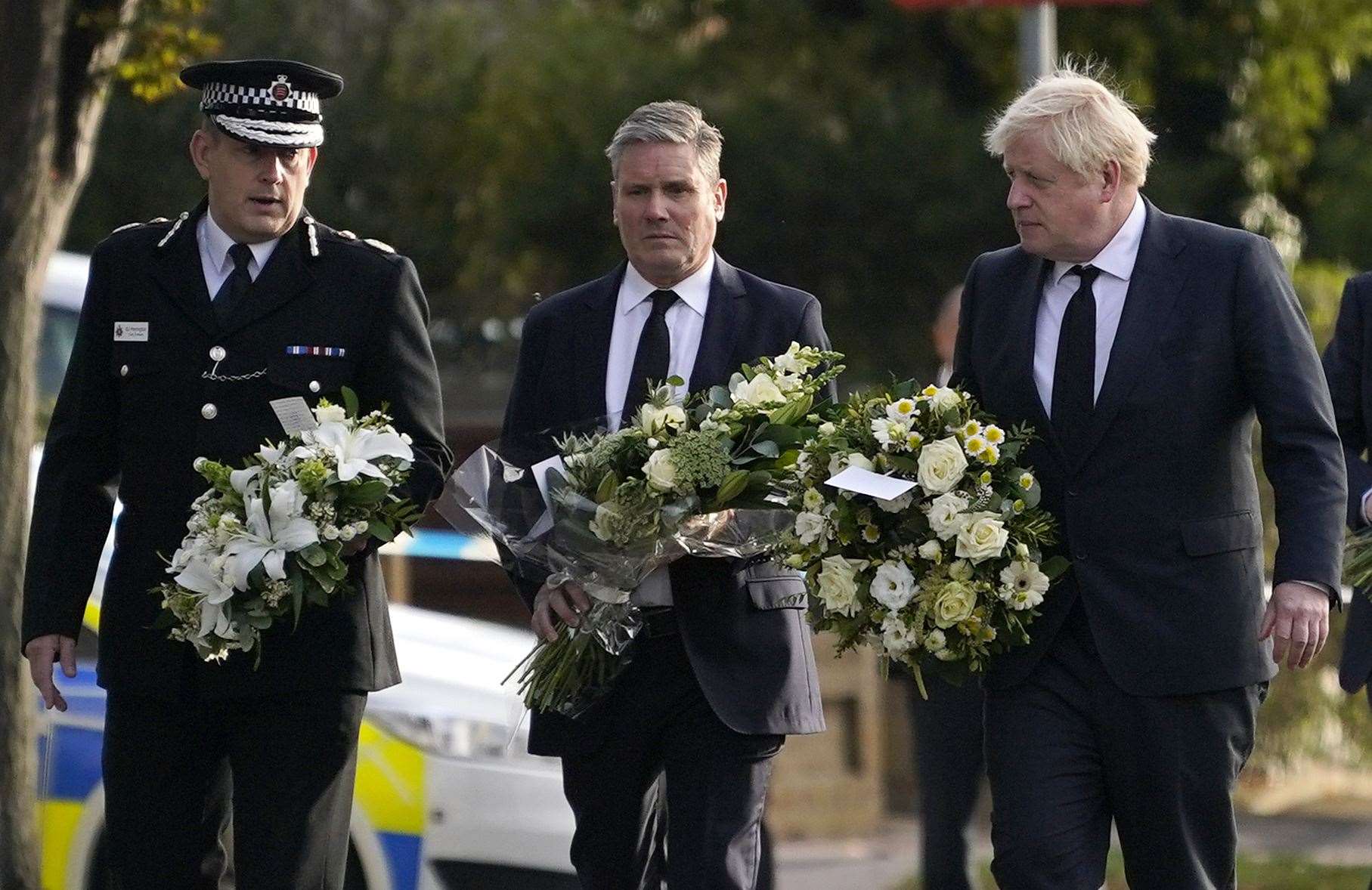 Boris Johnson, right, stood alongside Labour leader Sir Keir Starmer as they laid wreaths at the scene (Alberto Pezzali/AP)