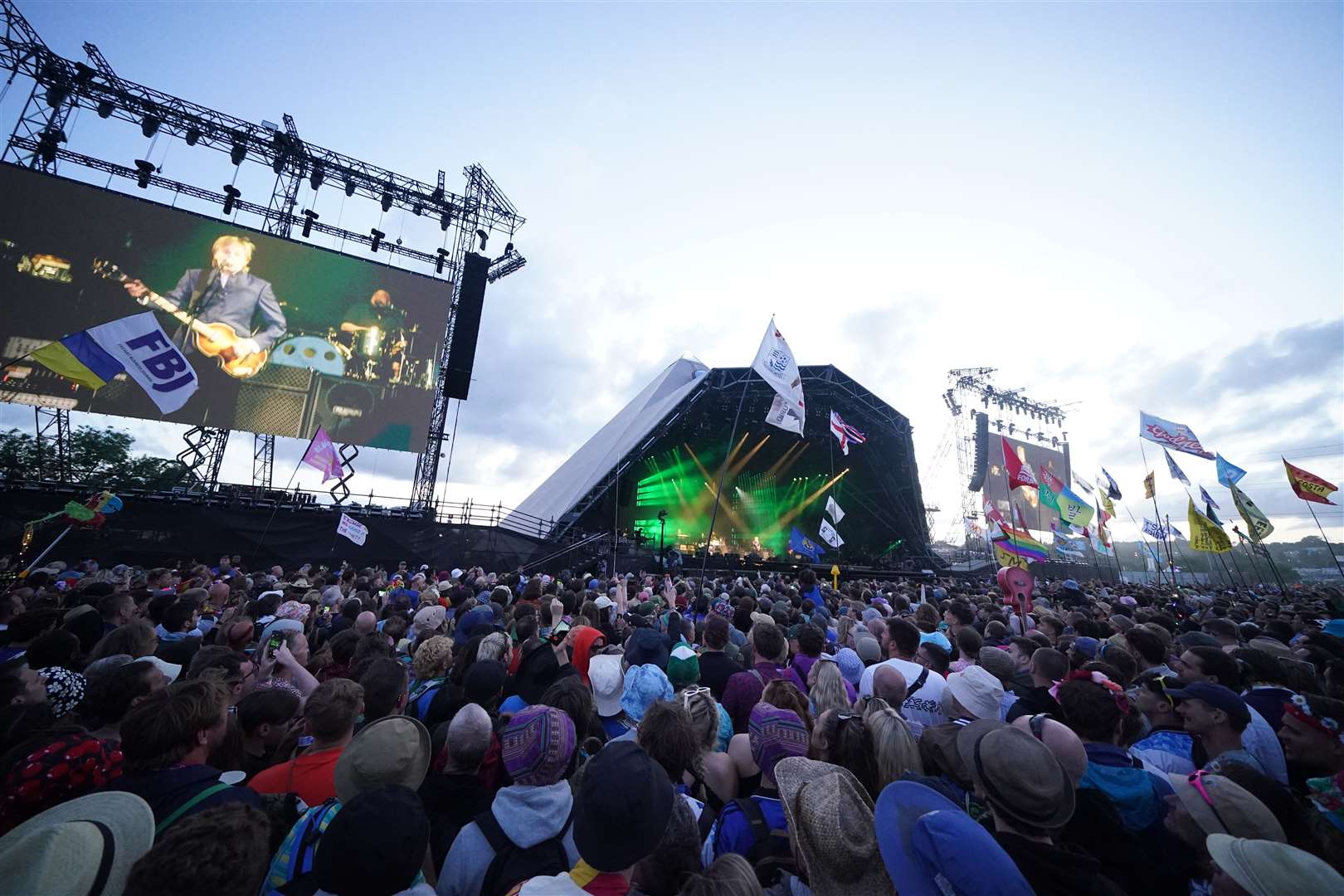 Sir Paul onstage as the crowds look on (Yui Mok/PA)