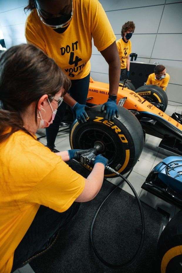 Duke of Edinburgh’s Award young people take part in a pit-stop challenge during a visit to the McLaren Technology Centre (Duke of Edinburgh’s Award)