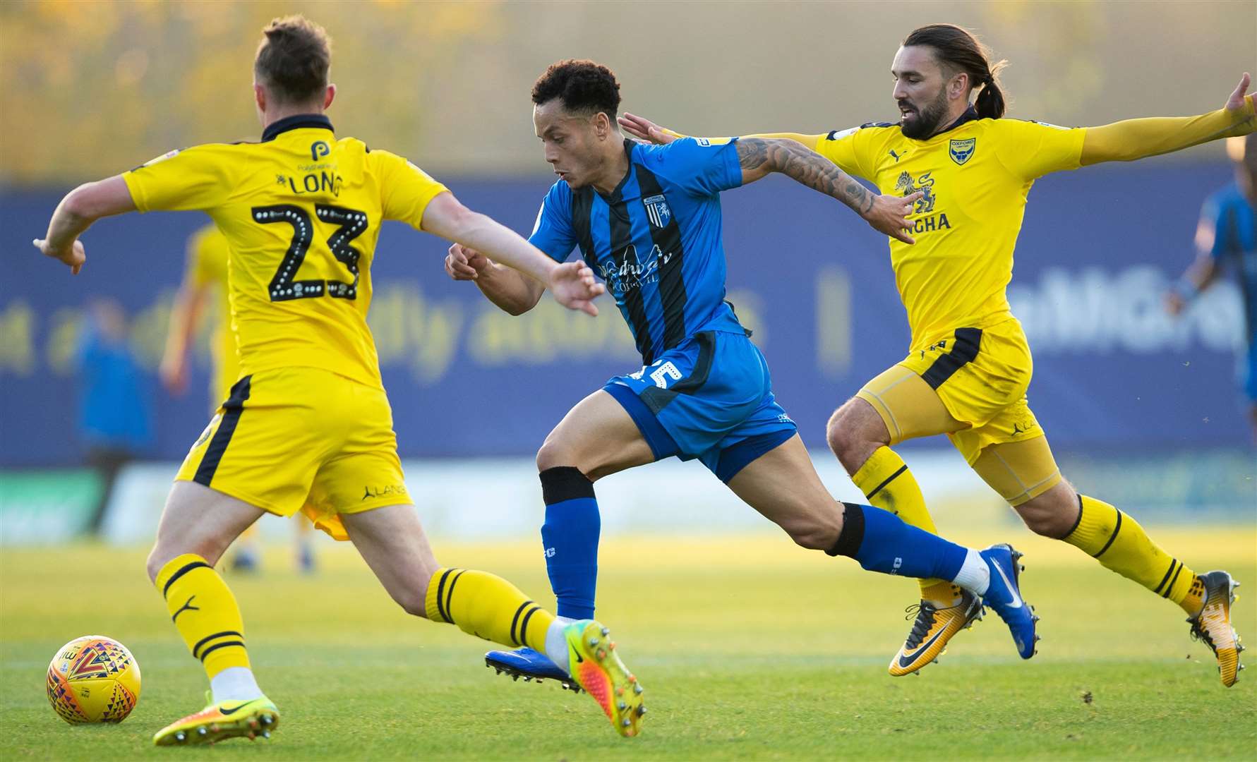 Ricky Holmes, right, gives chase against Gills for Oxford earlier this season but won't be able to take on his former side this weekend Picture: Ady Kerry