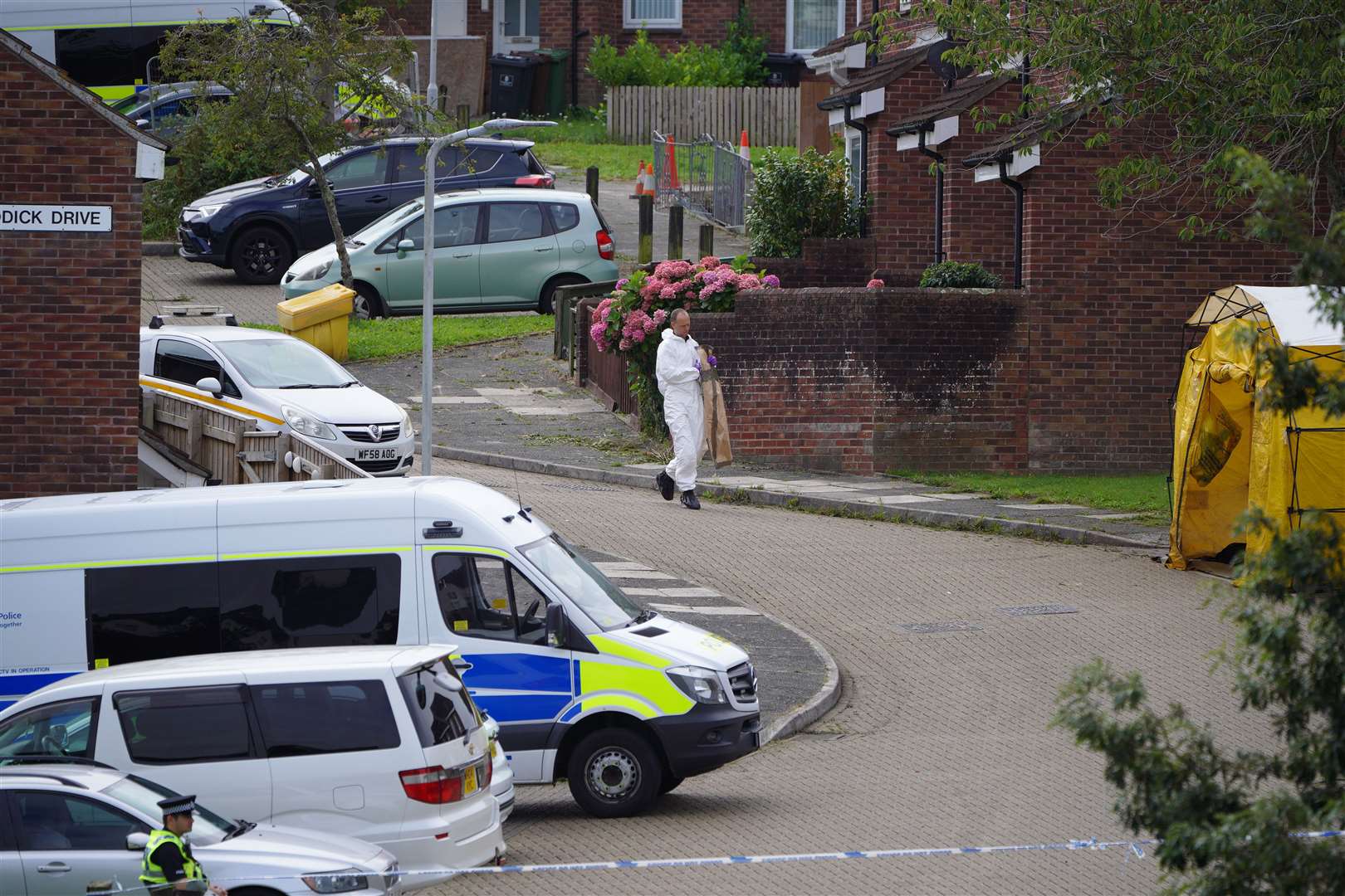 A forensic officer carries an evidence bag in Biddick Drive (Ben Birchall/PA)