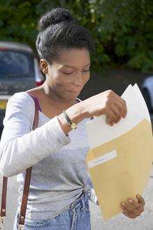 Bukayo Shoneyin, 15, opens her results at St John Fisher Catholic Comprehensive School, Chatham