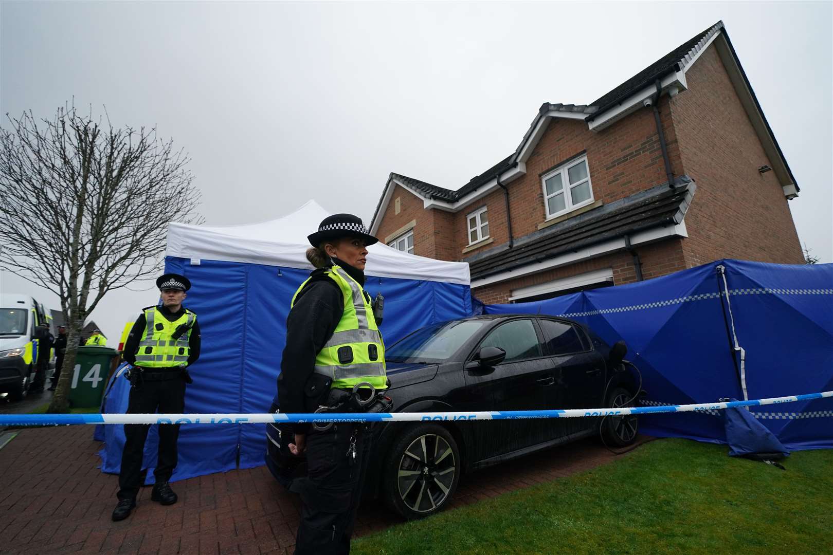 Officers from Police Scotland outside the home of former chief executive of the Scottish National Party Peter Murrell, in Glasgow (Andrew Milligan/PA)