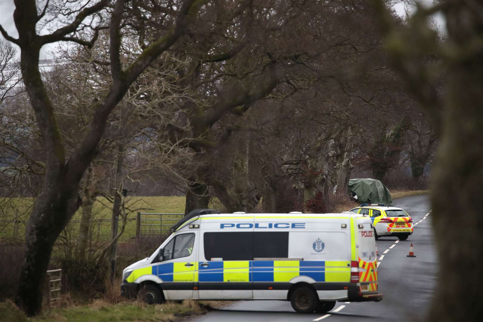 A covered vehicle at the scene on the C50, a minor road on the outskirts of Kilmarnock where a 40-year-old male driver was pronounced dead (Jane Barlow/PA)