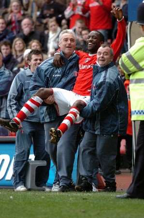 Chris Powell celebrates victory over Newcastle with Addicks coaching staff after the final whistle. Picture by MATTHEW WALKER