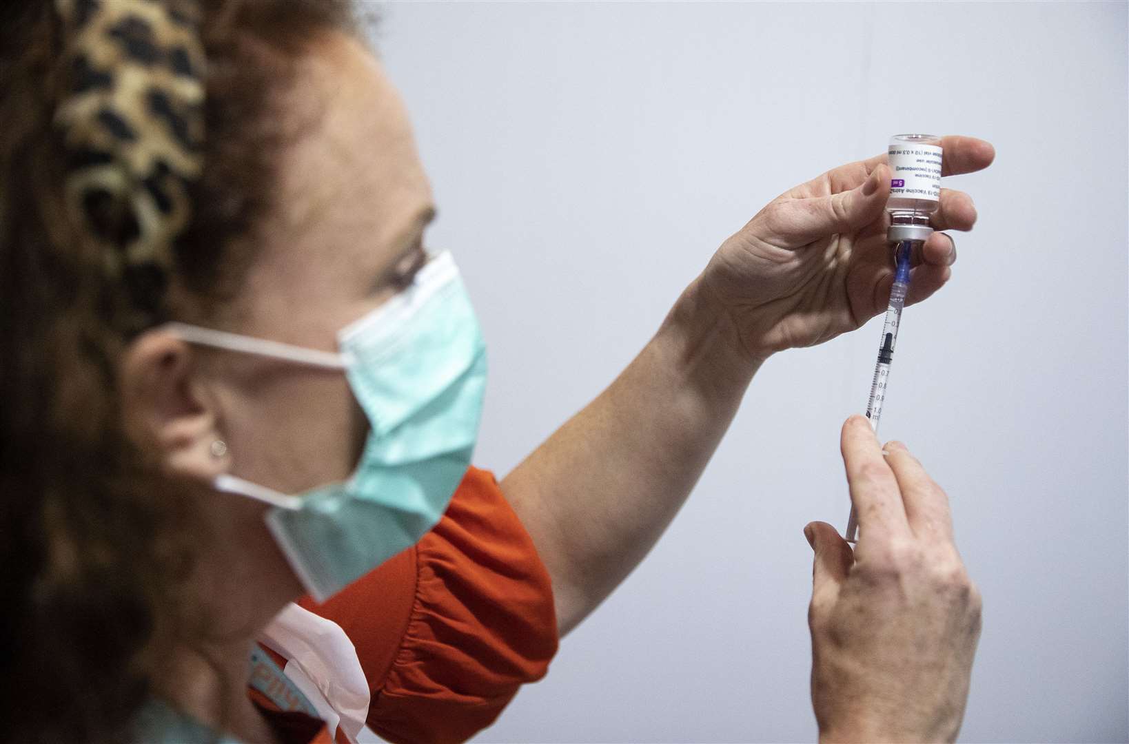 A nurse with a vial of the AstraZeneca vaccine (Brian Lawless/PA)