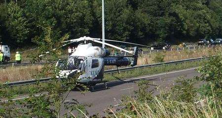 The Kent Air Ambulance lands near the scene of the crash. Picture: Stuart Watkins