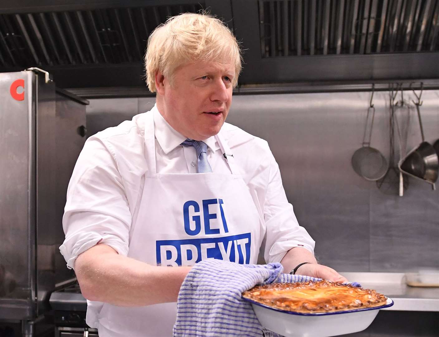 Mr Johnson holds a freshly-baked pie in Derby as he pushed his ‘oven-ready Brexit plan’ to the voters in late 2019 (Stefan Rousseau/PA)