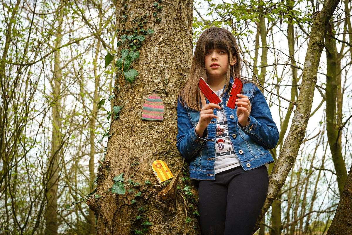 Hannah Haynes, 9, with one of the vandalised fairy doors at Newington near Sittingbourne. Picture: Phil Haynes