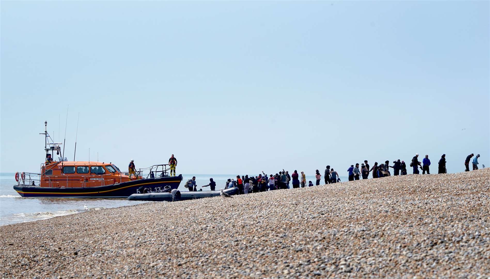 People though to be migrants are watched over by the RNLI (Gareth Fuller/PA)