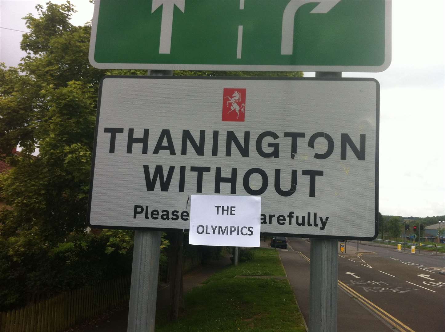 Angry residents in Thanington customised the welcome sign after it was snubbed for the relay route. Pic: Alex Perkins