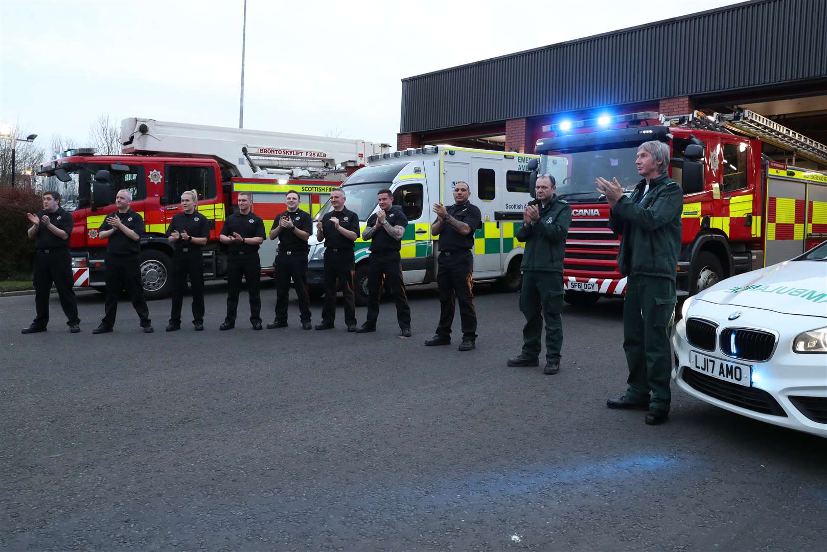 Fire and ambulance staff applauded outside Springburn community fire station in Glasgow (Andrew Milligan/PA))