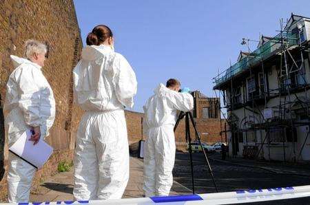 Crime Scene Investigation officers at the scene.