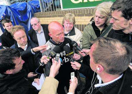 Mark Stimson is surrounded by reporters after Gillingham's relegation