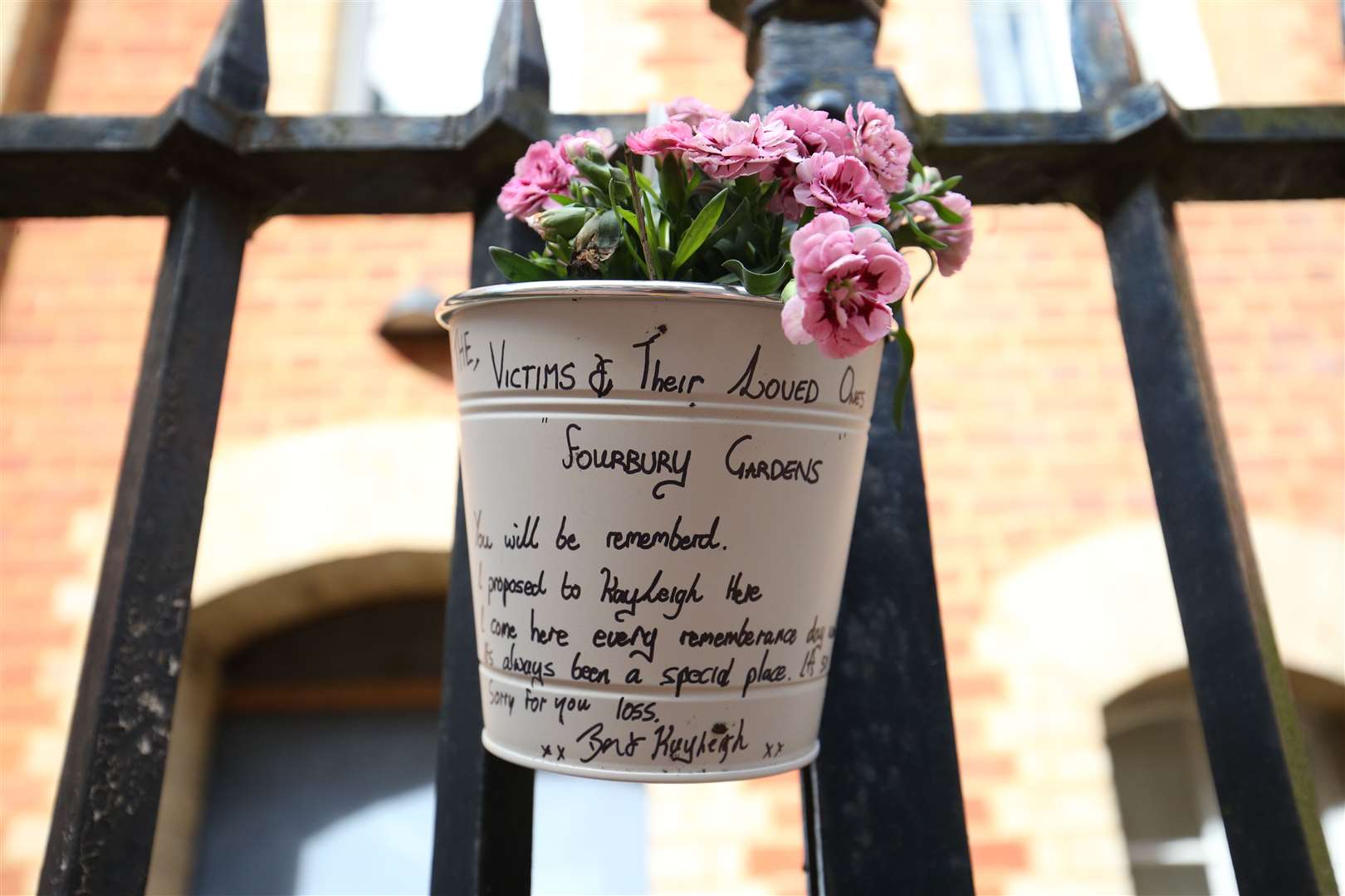 Flowers and a message left at the Abbey gateway of Forbury Gardens (Jonathan Brady/PA)