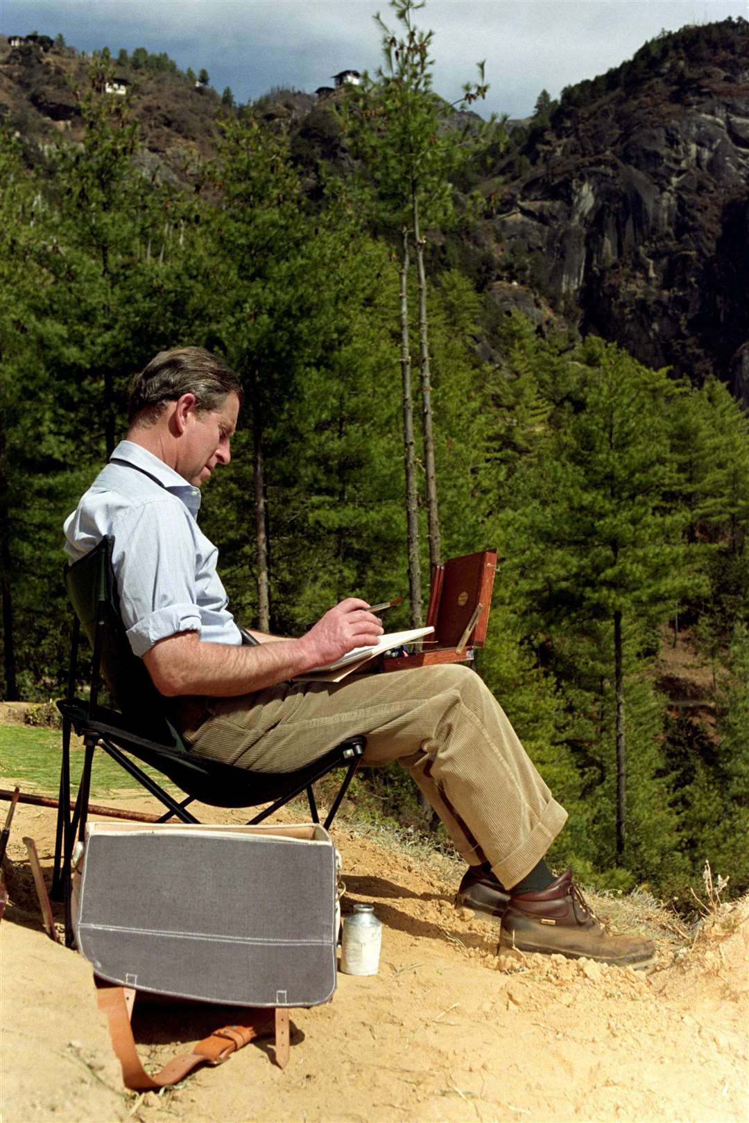 Charles painting in Paro, Bhutan, while on a royal visit in 1998 (John Stillwell/PA)