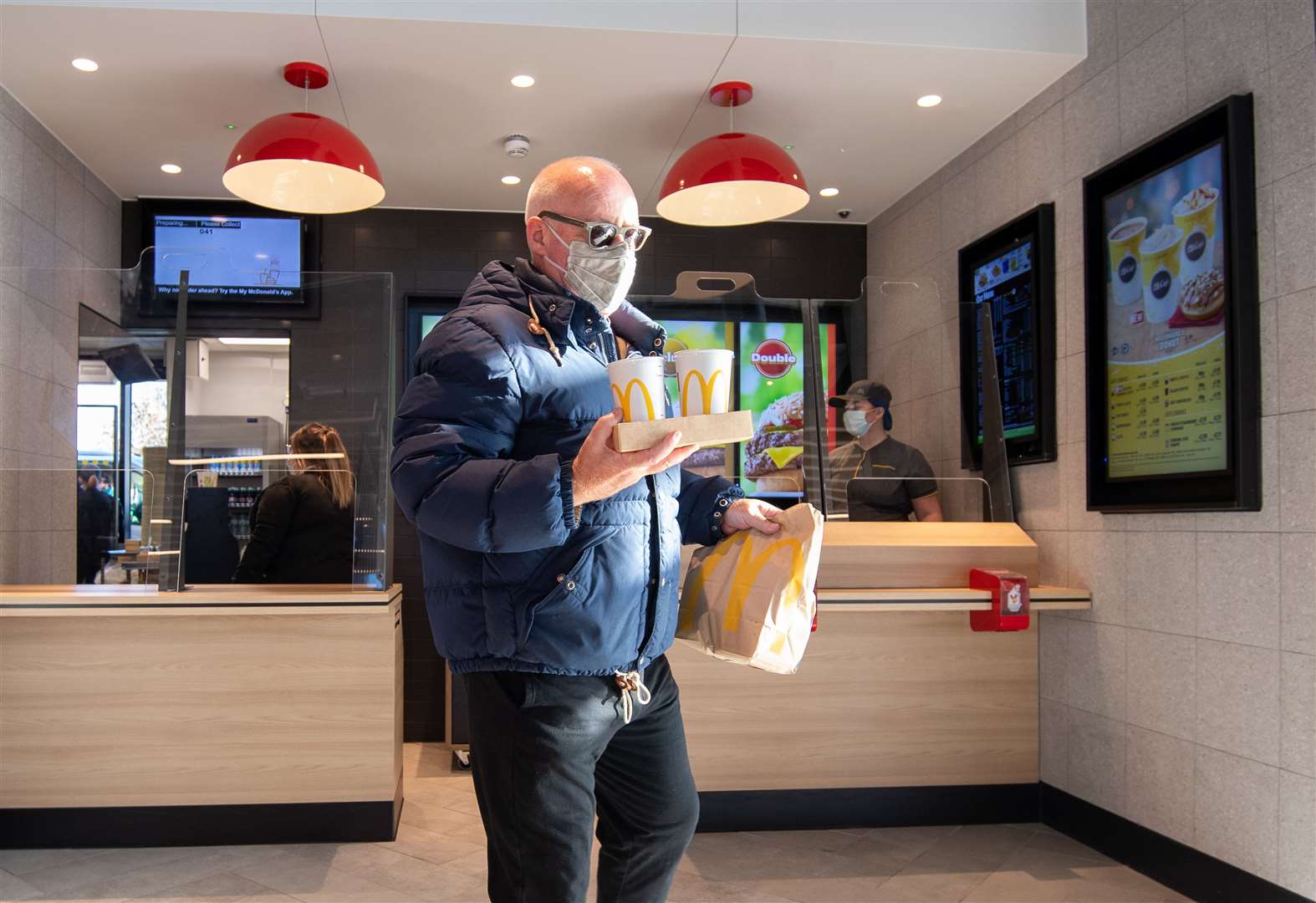 A customer collects his order at the new McDonald’s restaurant (Joe Giddens/PA)