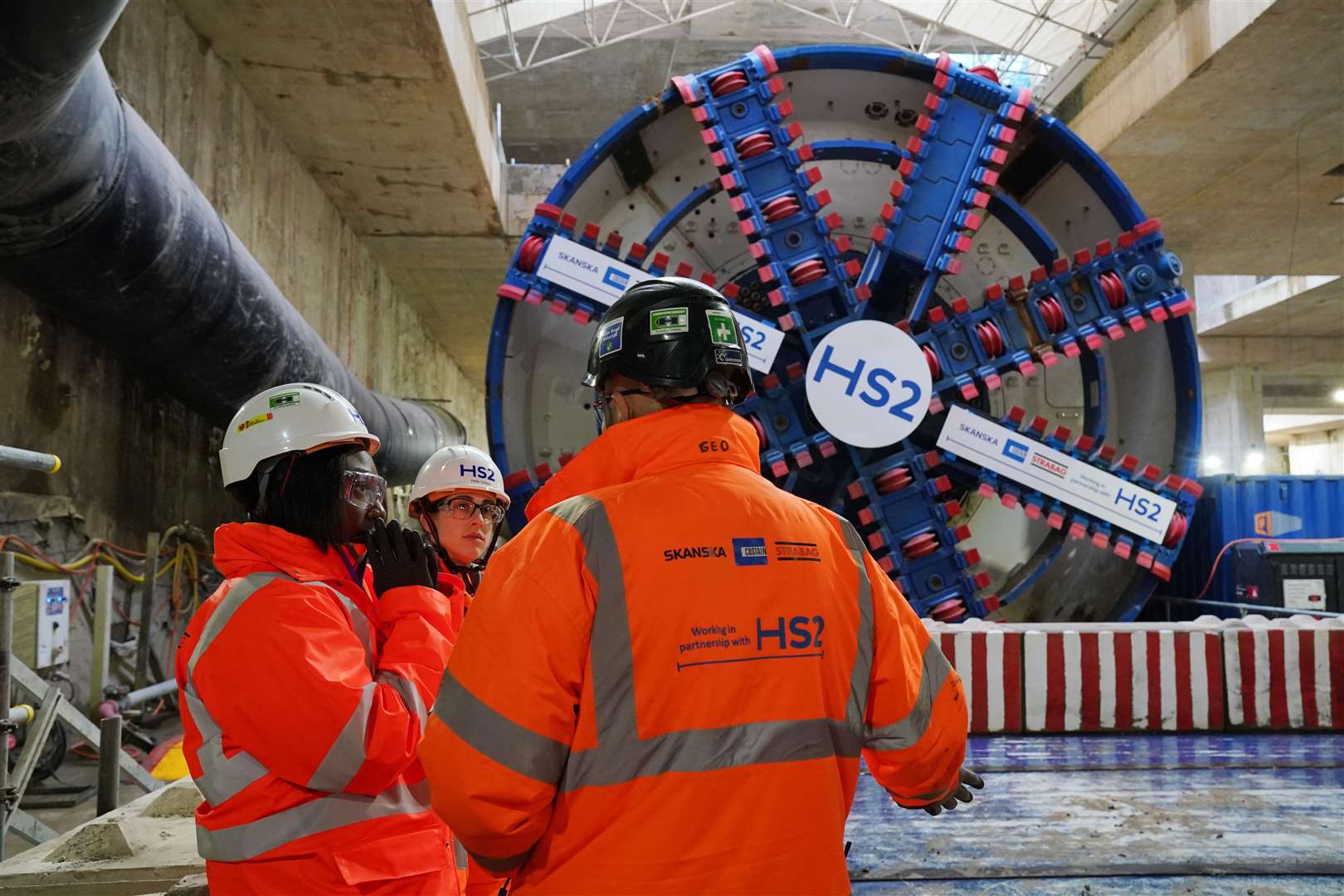 HS2 workers stand in front of tunnel boring machine Karen (Jonathan Brady/PA)