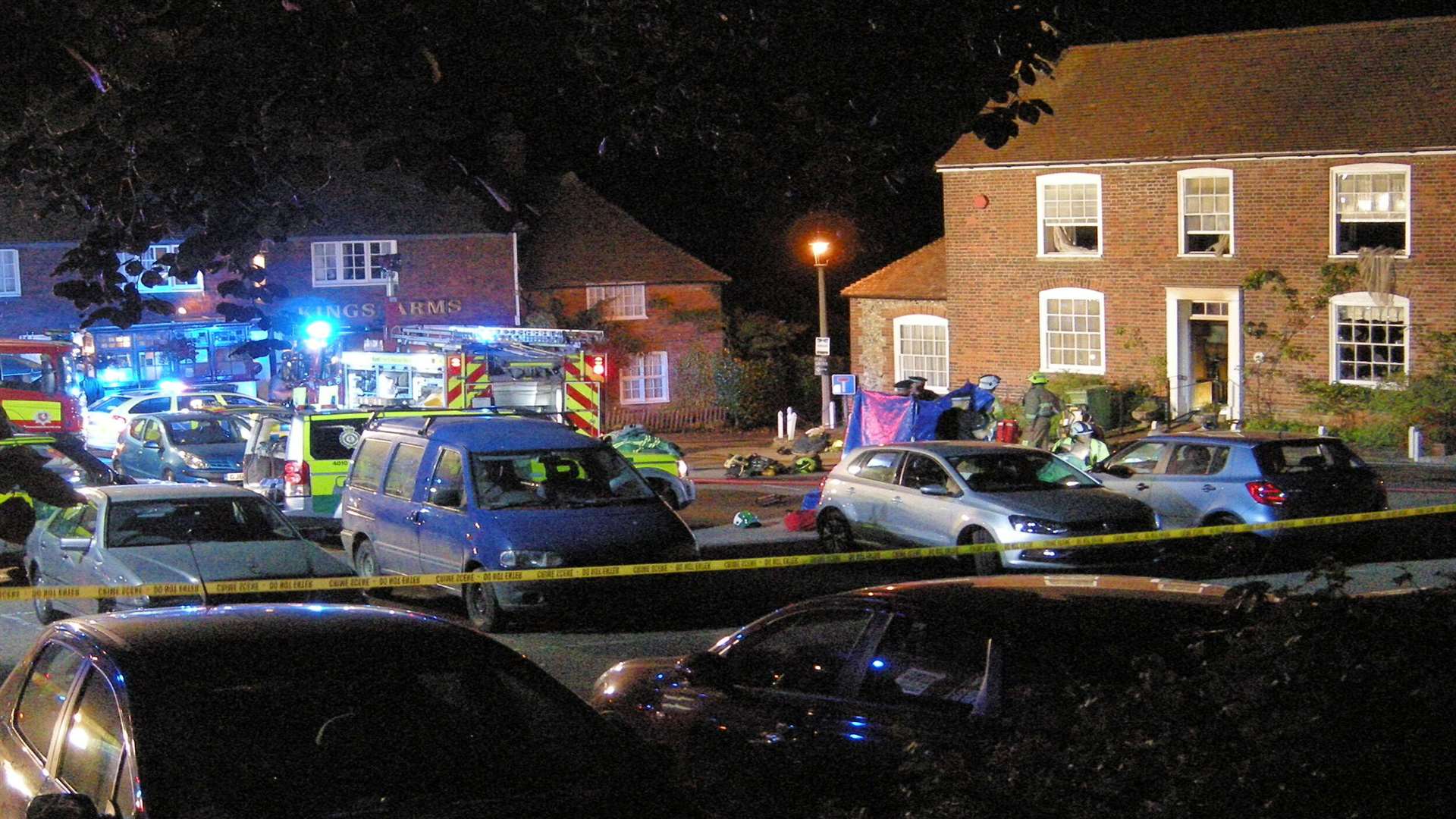 Rescuers outside the fire-ravaged home