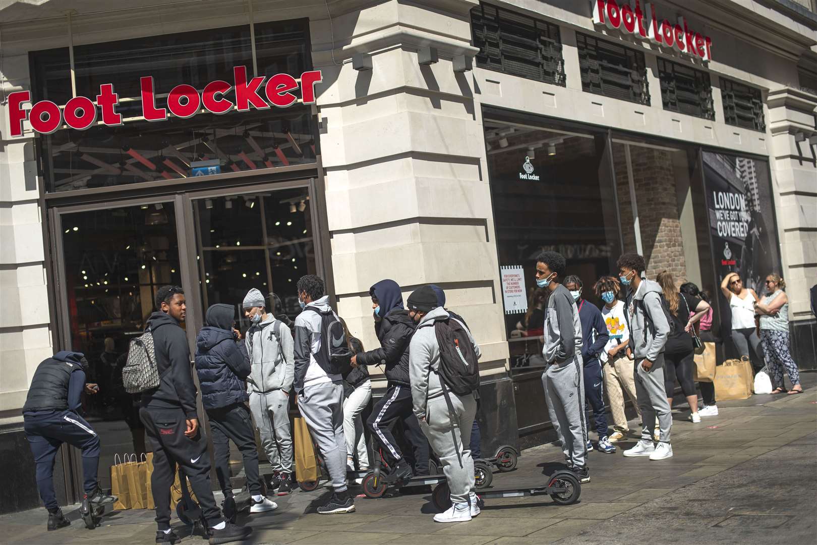 Customers queue to enter Foot Locker in Oxford Street (Victoria Jones/PA)