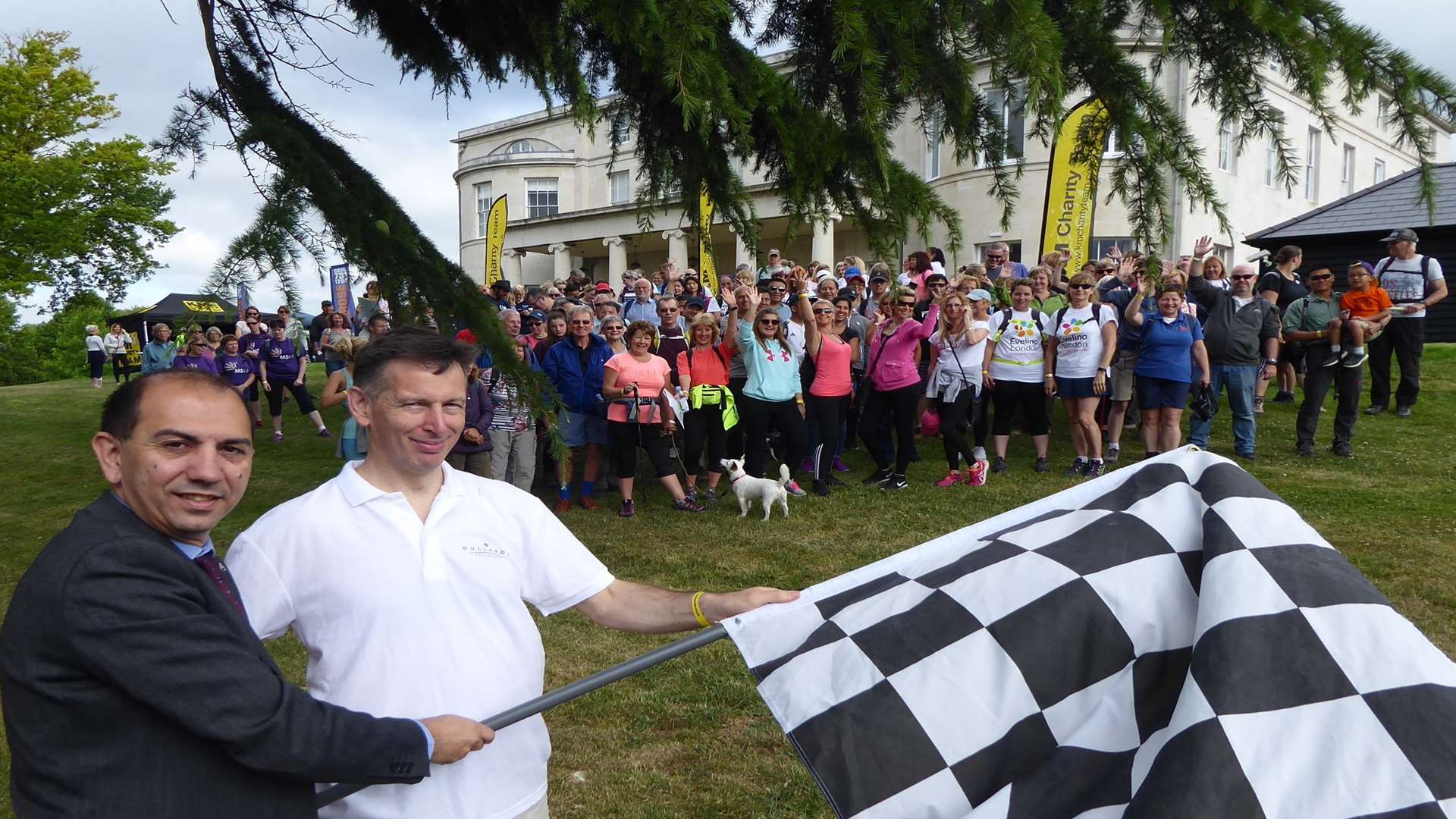 Jose Afonso of Mote House and Andrew Clarke of Gullands start the KM Charity Walk cheered on by hundreds of walkers.