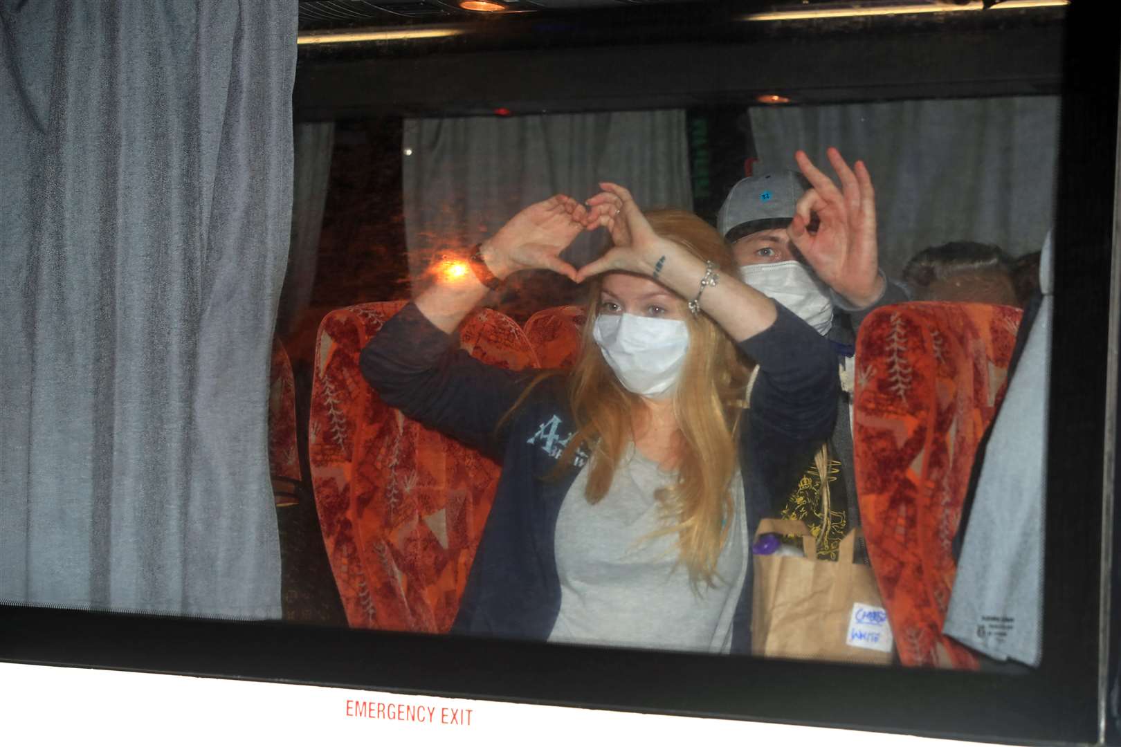 Passengers of an aircraft that repatriated British people to the UK from a cruise ship hit by the coronavirus in Yokohama, Japan, arrive by coach at Arrowe Park Hospital on Merseyside (Danny Lawson/PA)