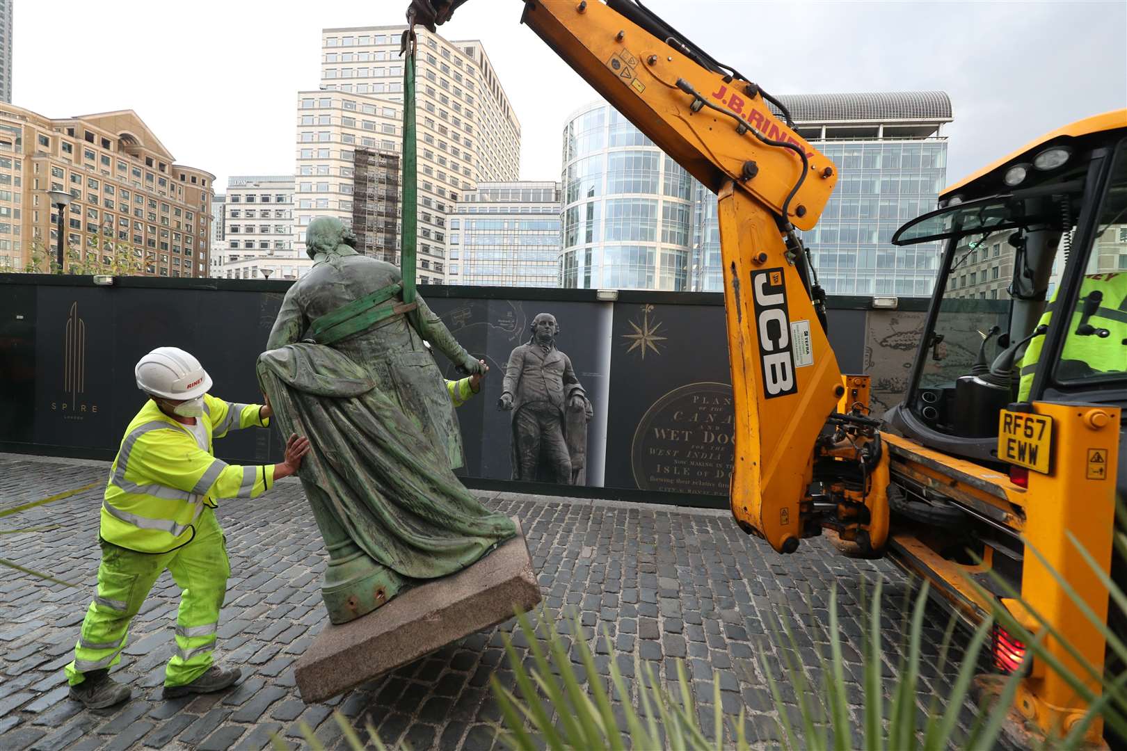 Workers take down a statue of slave owner Robert Milligan at West India Quay (Yui Mok/PA)