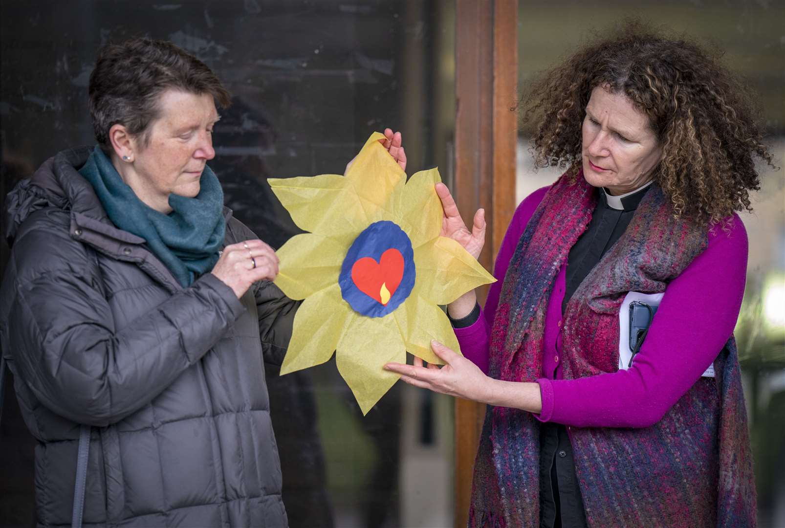 Reverend Dr Harriet Harris (right) takes part in the vigil (PA)