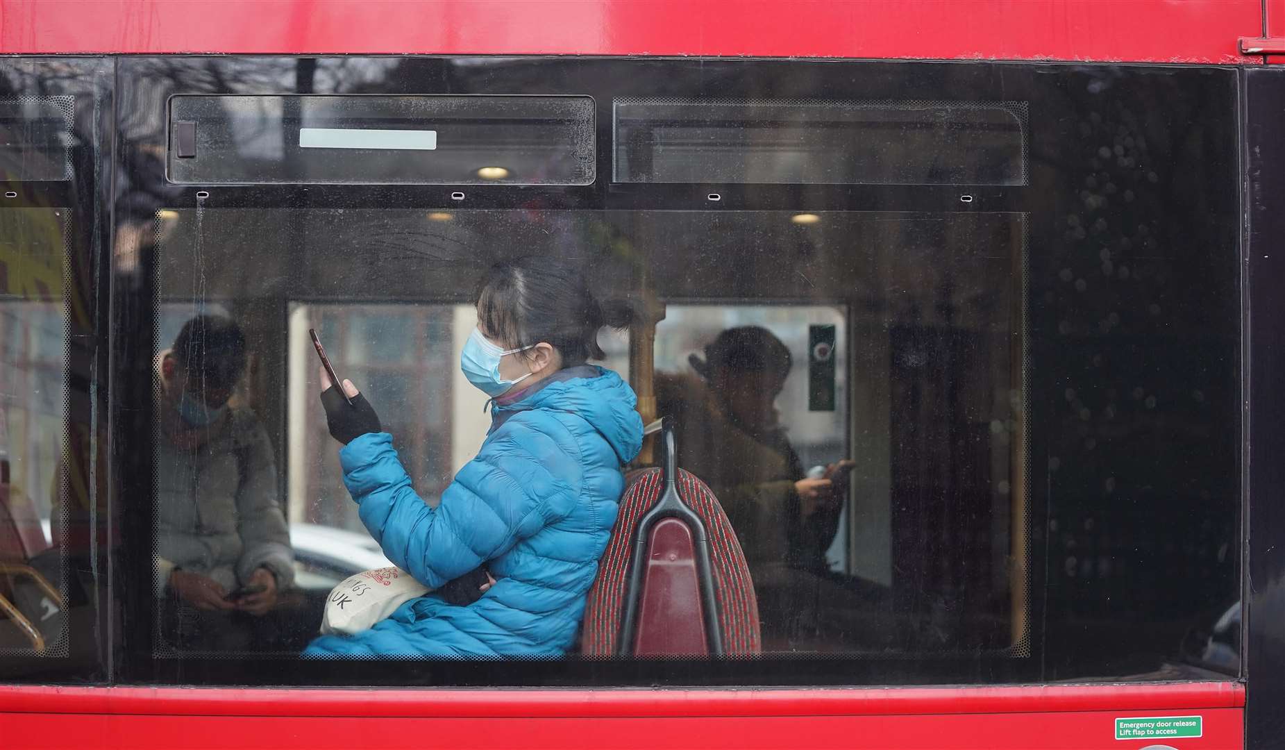 A person sitting on a bus in London (Stefan Rousseau/PA)